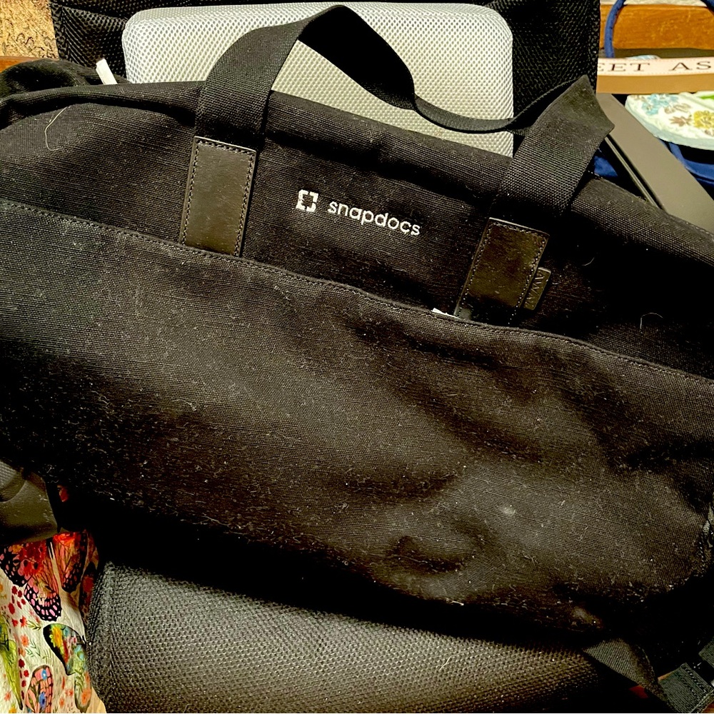 Large Snapdocs black duffle bag with hand or shoulder straps.